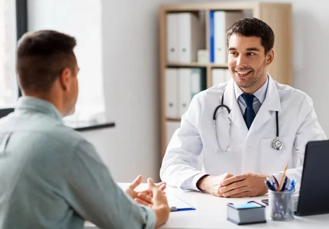 A man reviewing his hormone lab results with a physician during a BHRT consultation
