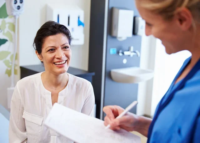 A woman discussing bioidentical hormone replacement therapy options during a consultation