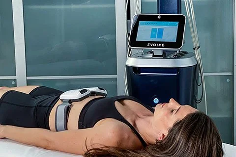 A patient receiving a non-invasive EvolveX body sculpting treatment