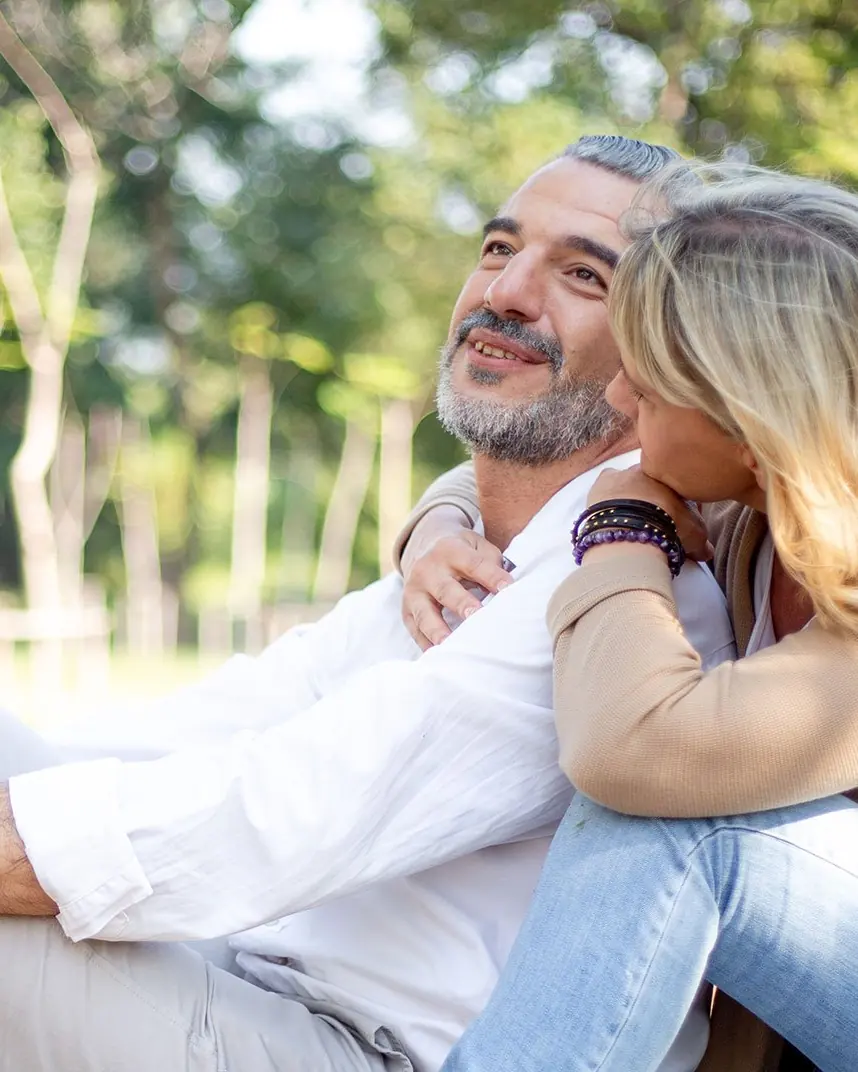 A couple relaxing together in a sunlit park